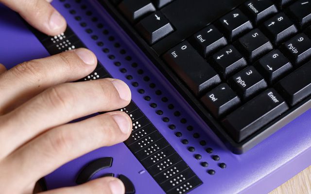 Photo: Person using a Braille Display
